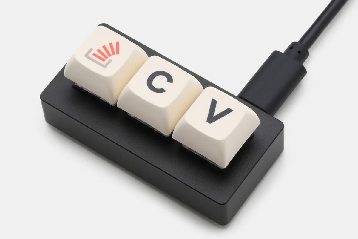 Image of a 3 button macro keyboard, the 3 buttons being: A stack overflow icon, a capitialized C, and a capitialized V.